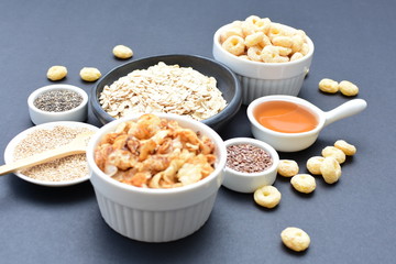 Granola mix accompanied by seeds and honey