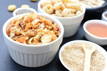 Granola mix accompanied by seeds and honey