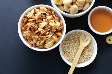 Granola mix accompanied by seeds and honey