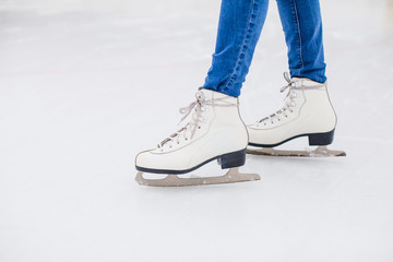 Skates on the rink close up legs
