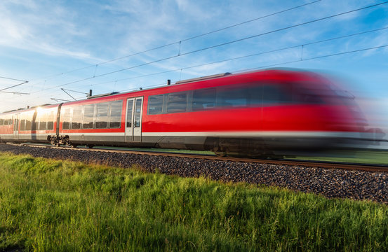 High-speed german train traveling through nature. Summer travel