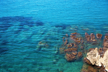 Water surface. Turquoise sea Beach and wave of Tyrrhenian Sea in Sicily. Natural environmental background. Summer day.