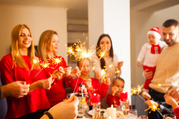 Close up lighted sparkles with people standing on the background