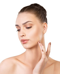 Young woman applying liquid foundation on white background
