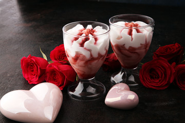 Strawberry dessert or ice cream in glasses and rose, decorated with hearts. Valentines Day background