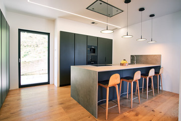 Modern kitchen with counter and chairs