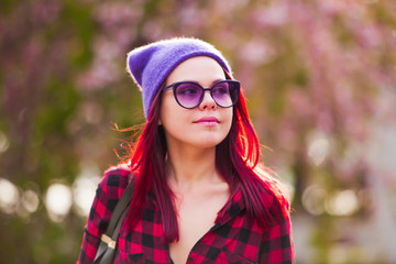 Young smiling woman with fuchsia colored hair