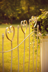 Heart-shaped fence design as a decoration at an outdoor wedding
