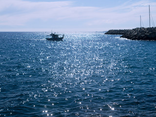 Glittering sea and fishing boat 