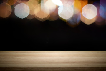 Empty wooden table platform and bokeh at night.