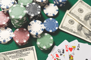 Poker chips, cards on green table
