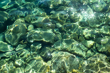 Fototapeta na wymiar Stones under transparent sea water