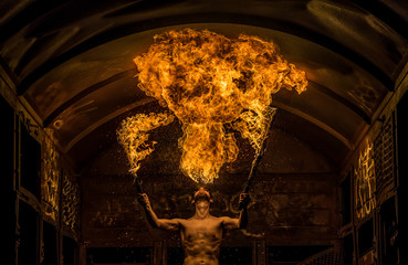 Fire Spitting Man with two Burning Swords