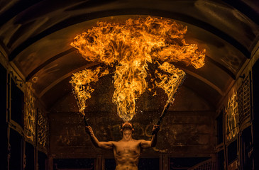 Fire Spitting Man with two Burning Swords