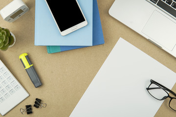 Top view of a working desk with open blank paper