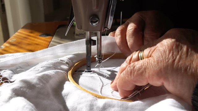 An Old Woman is Working with a Sewing Machine, 4k