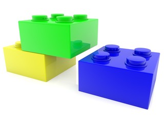 Three different colored toy bricks in unfinished construction on white
