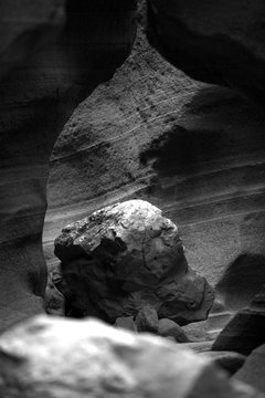 black and white photo of stone formation in a canyon 