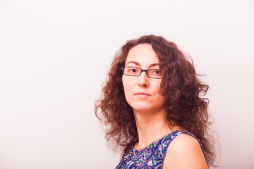 Portrait of attractive serious woman wearing eyeglasses