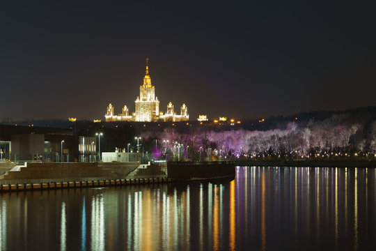 Long exposure photography of the  Vorobyevy Gory / Gorky park in the autumn night. Moscow State University of Stalinist neoclassical style named after Lomonosov in distance. 