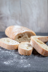 Bread with Flour on Wood Plate