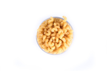 Glass jar filled with dry rotini yellow pasta over isolated white background
