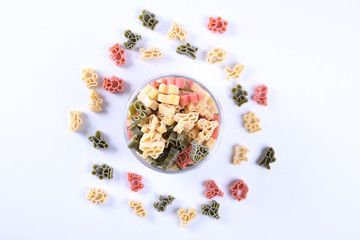 Glass jar filled with dry rotini yellow pasta over isolated white background