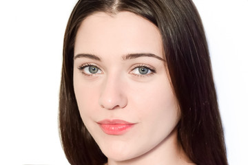 Naklejka premium Portrait of a dark haired caucasian girl on a white background. The face of a young woman close-up.