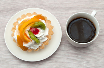 dessert with fruits, cream and cup of coffee. view from above. on wooden background.