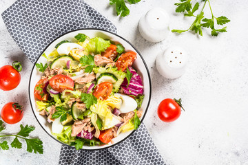Tuna salad with green leaves, eggs and vegetables.