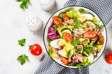 Tuna salad with green leaves, eggs and vegetables.