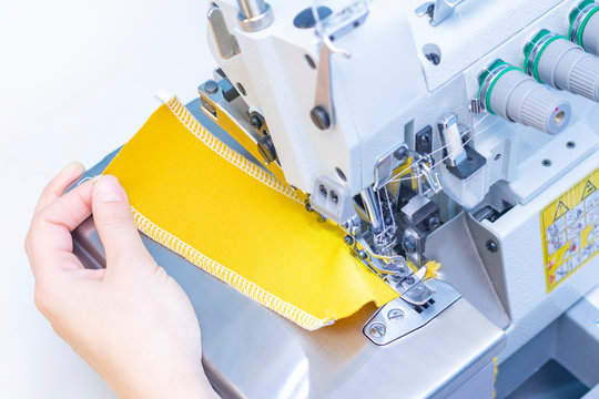 Sewing studio. Seamstress patch fabric. Overlock stitch. Overlock for sewing fabric. Tailoring