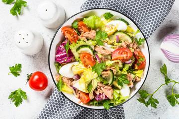 Tuna salad with green leaves, eggs and vegetables.