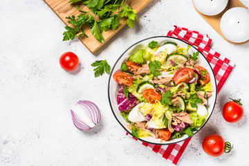 Tuna salad with green leaves, eggs and vegetables.