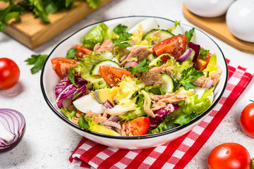 Tuna salad with green leaves, eggs and vegetables.