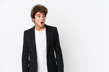Young caucasian business man against a white background isolated being shocked because of something...