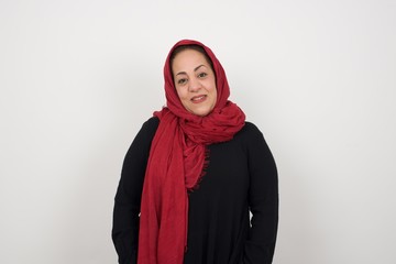 Young beautiful woman over isolated background happy face smiling with hands in pockets looking at the camera. Positive person.