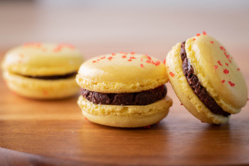 Lemon Yellow Macaron Cookies on Wood Cutting Board