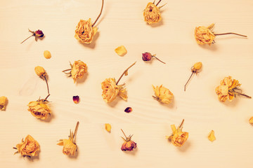 Flower composition made of dried rose buds  on wooden background. Beautiful backdrop for blogs,...