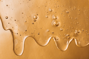 Hyaluronic acid gel. Textured background with oxygen bubbles on silver background.