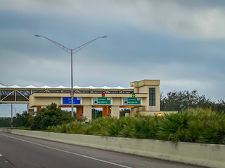 Fototapeta na wymiar Highway Toll Plaza In Orlando Florida In Color Under Cloudy Sky