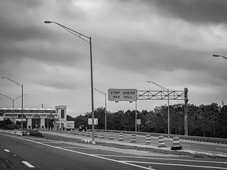 Highway Toll Plaza In Orlando Florida Under Dark Clouds In Black & White