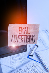 Conceptual hand writing showing Email Advertising. Concept meaning act of sending a commercial message to target market Note paper taped to black screen near keyboard stationary