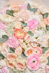 Closeup beautiful bouquet of mixed flowers. Work of the florist at a flower shop. Delivery fresh cut flower. European floral shop.