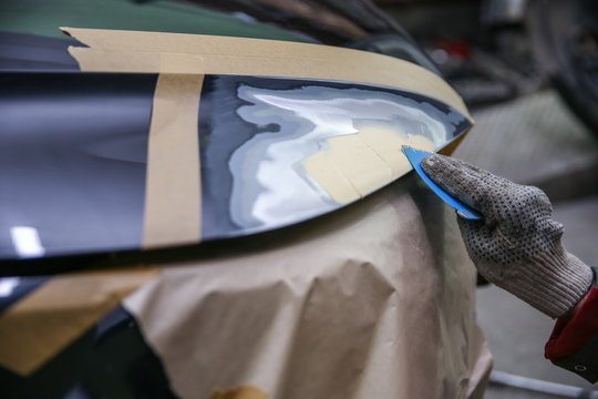 local repairing car body with putty close up