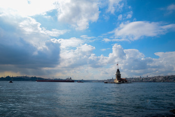 Maiden Tower or Kiz Kulesi with floating tourist boats on Bosphorus in Istanbul