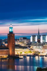 Foto op Canvas Stockholm, Sweden. Scenic Skyline View Of Famous Tower Of Stockholm City Hall And St. Clara Or Saint Klara Church. Popular Destination Scenic View In Sunset Twilight Dusk Lights. Evening Lighting © Grigory Bruev