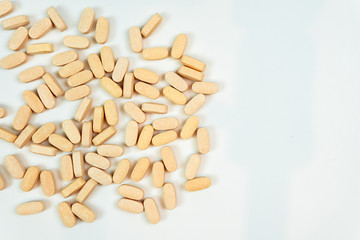 orange vitamin c pills isolated on white background