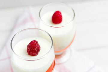 Delicious italian dessert panna cotta with berry jelly on wooden background, food concept