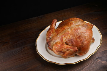 homemade roasted chicken on dark wooden background